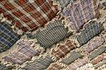 The quilt hangs above me